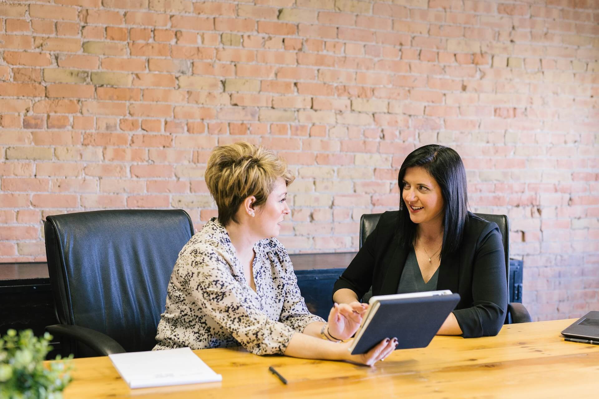 hr recruitment specialist sat down at a desk with a staff member